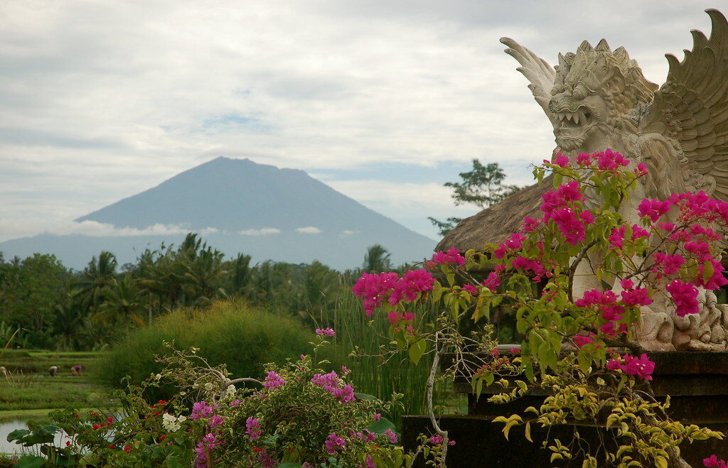 Agung framed by a temple gate and bougainvillea.