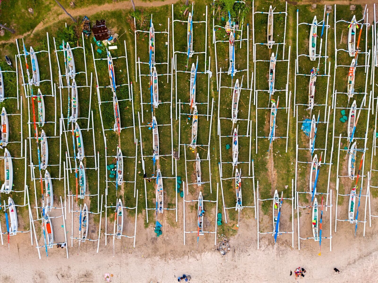 The jukung fishing fleet drawn up on the sand, seen from above.