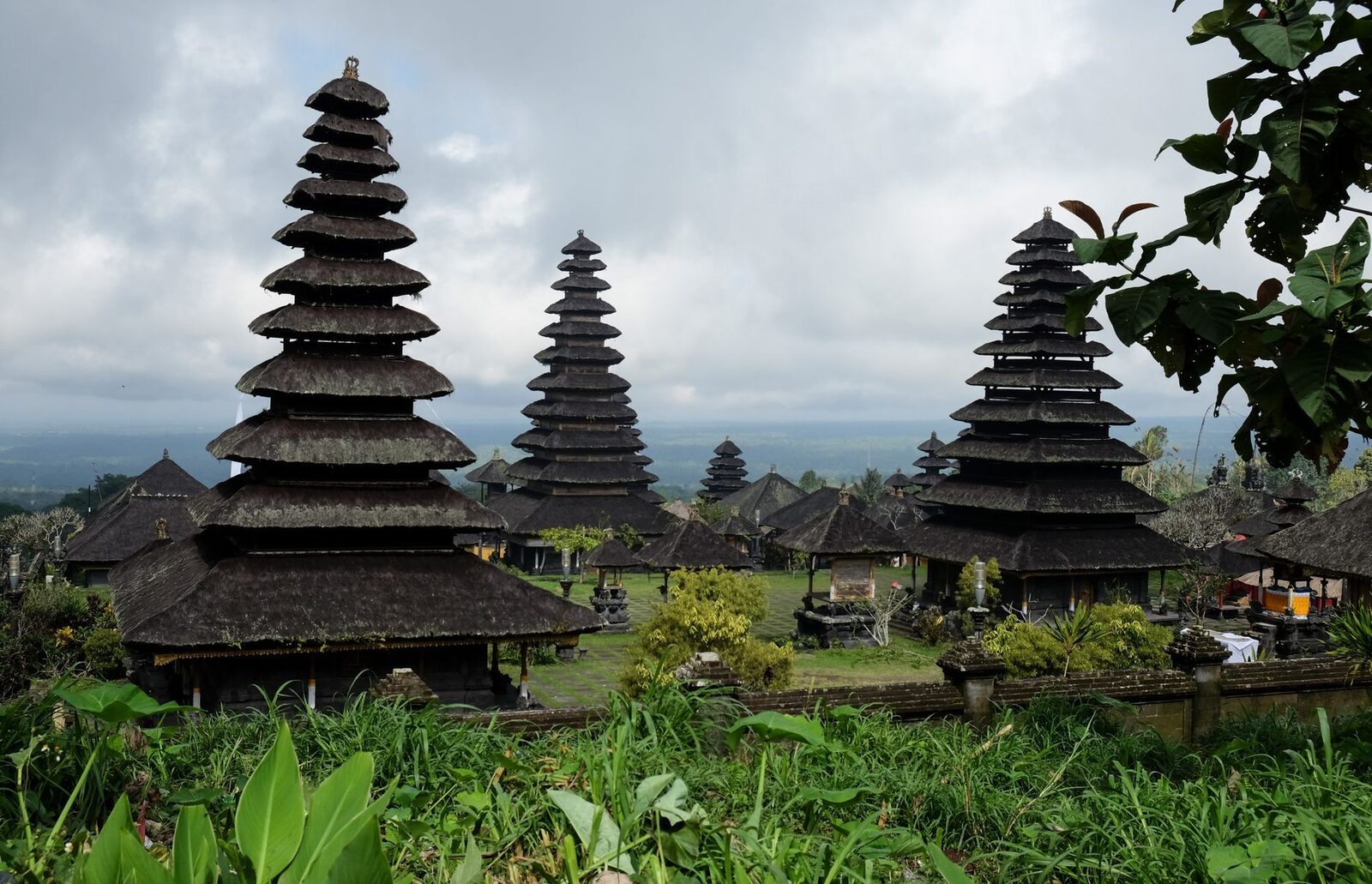 Meru towers against the cloud, greenery crowding the courtyards.