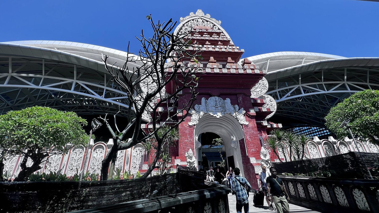 The split temple gate that fronts Ngurah Rai (DPS) — your first taste of Bali, and of the transport scramble, right when you land tired.