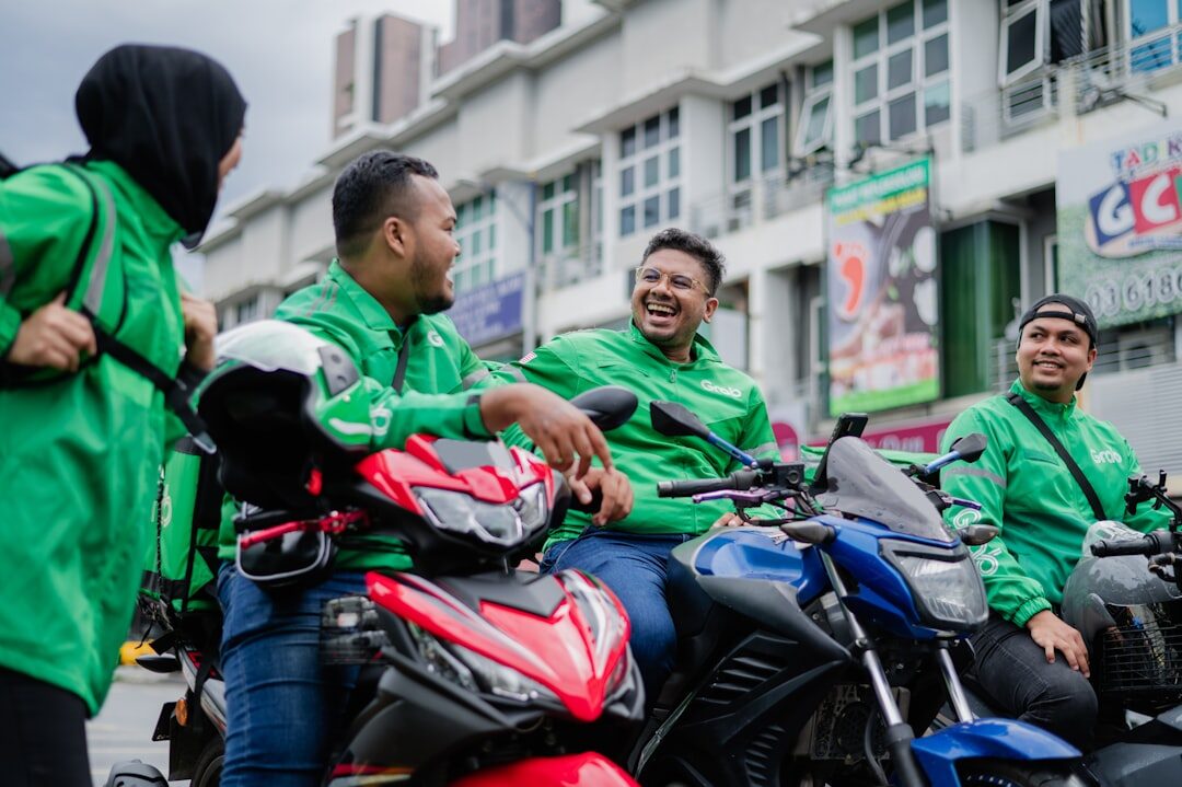 A knot of ride-hailing drivers on their scooters between jobs.