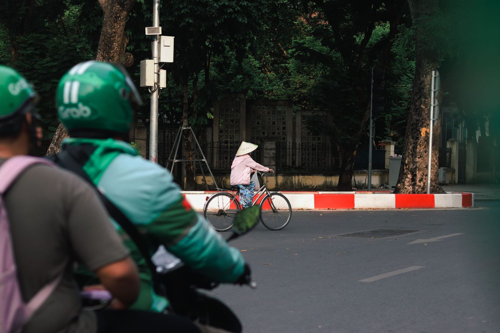 App drivers idling on their bikes at the roadside, waiting on the next booking.