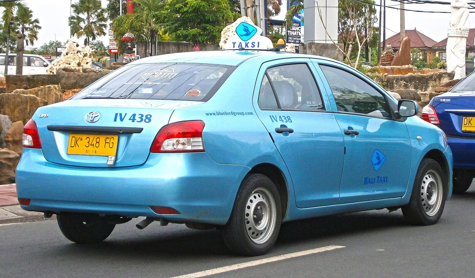 A Blue Bird taxi in traffic, the reputable metered blue among the everyday cars.
