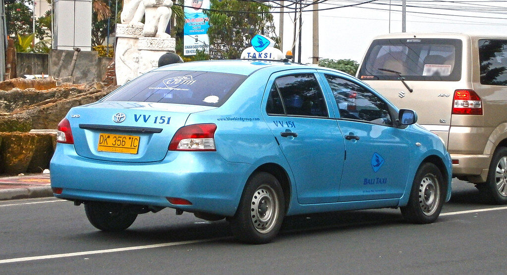 Another Blue Bird cab working the street — insist on the meter the moment you're in.