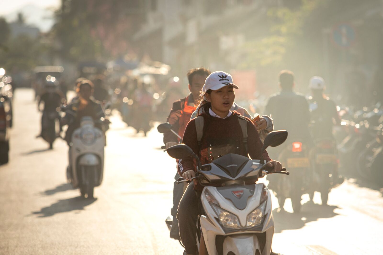Riders inching through traffic in the low sun, the road choked ahead.