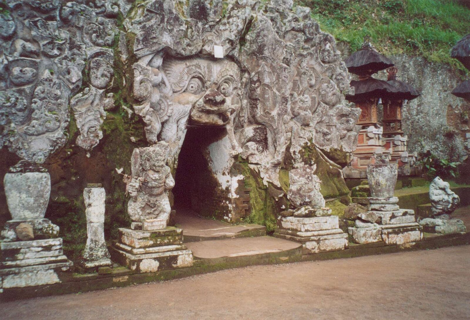 The entrance beside a small shrine, in an older, quieter shot.