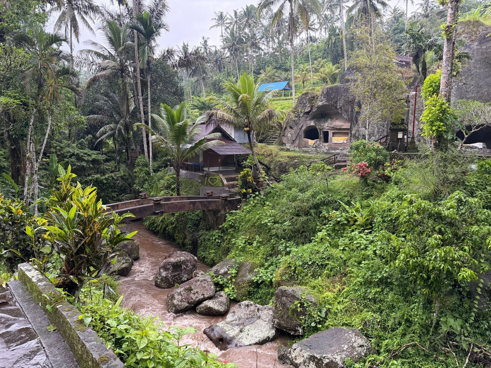 The lower grounds seen from above, rocks and relics scattered through the green.