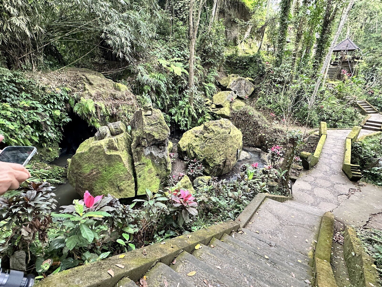 The path down into the valley below the cave — stone steps, boulders and shrines most visitors never bother to reach.