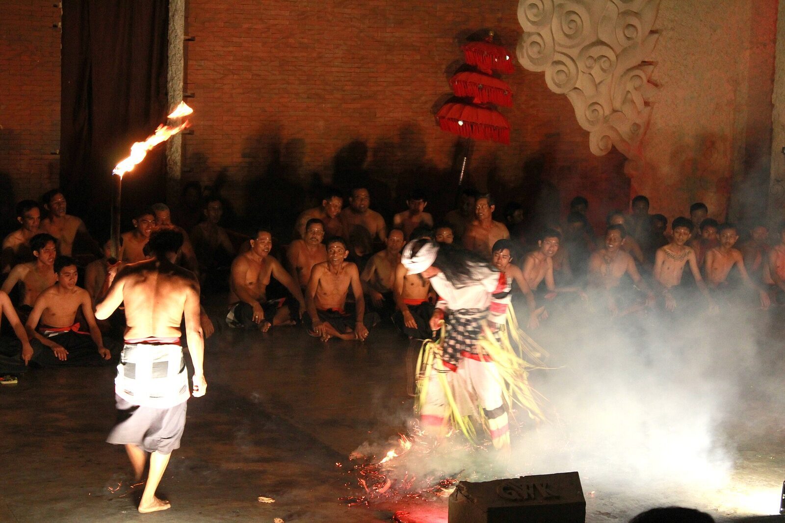 The Kecak fire dance, flames and smoke on the open stage as the story reaches its climax.