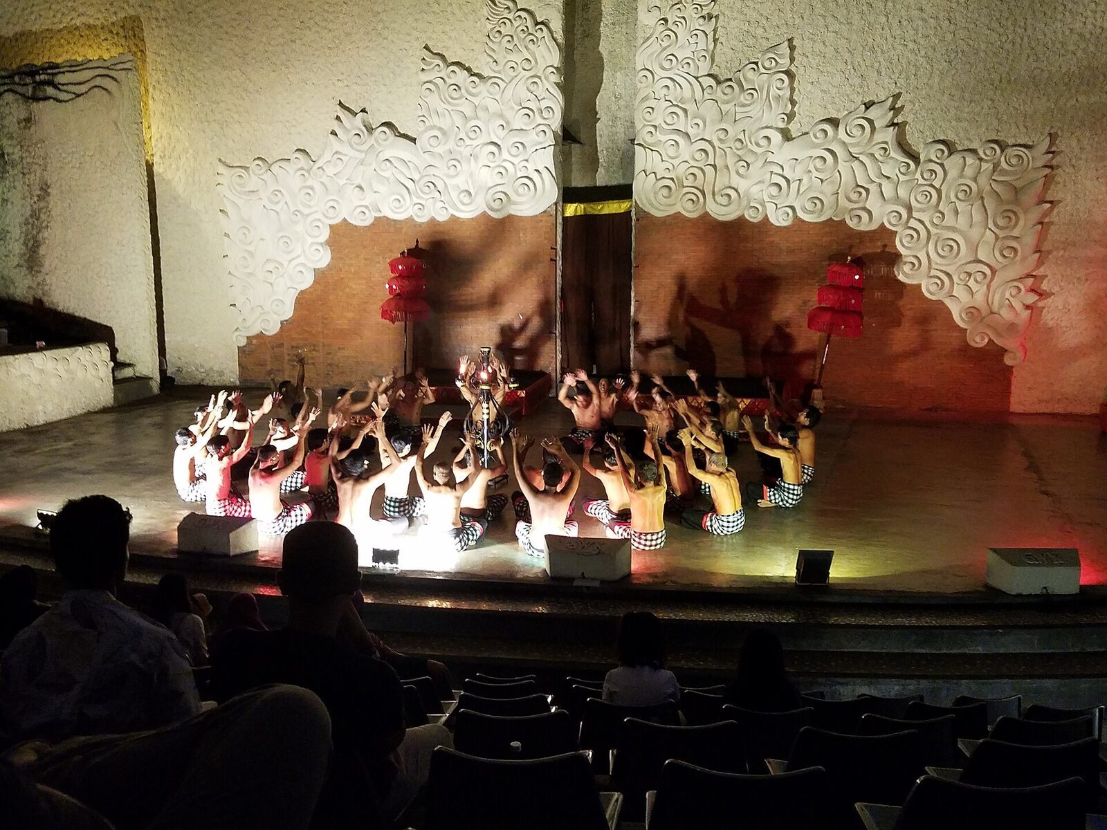A full Kecak performance in the park's amphitheatre, the ring of seated men lit against the wall.