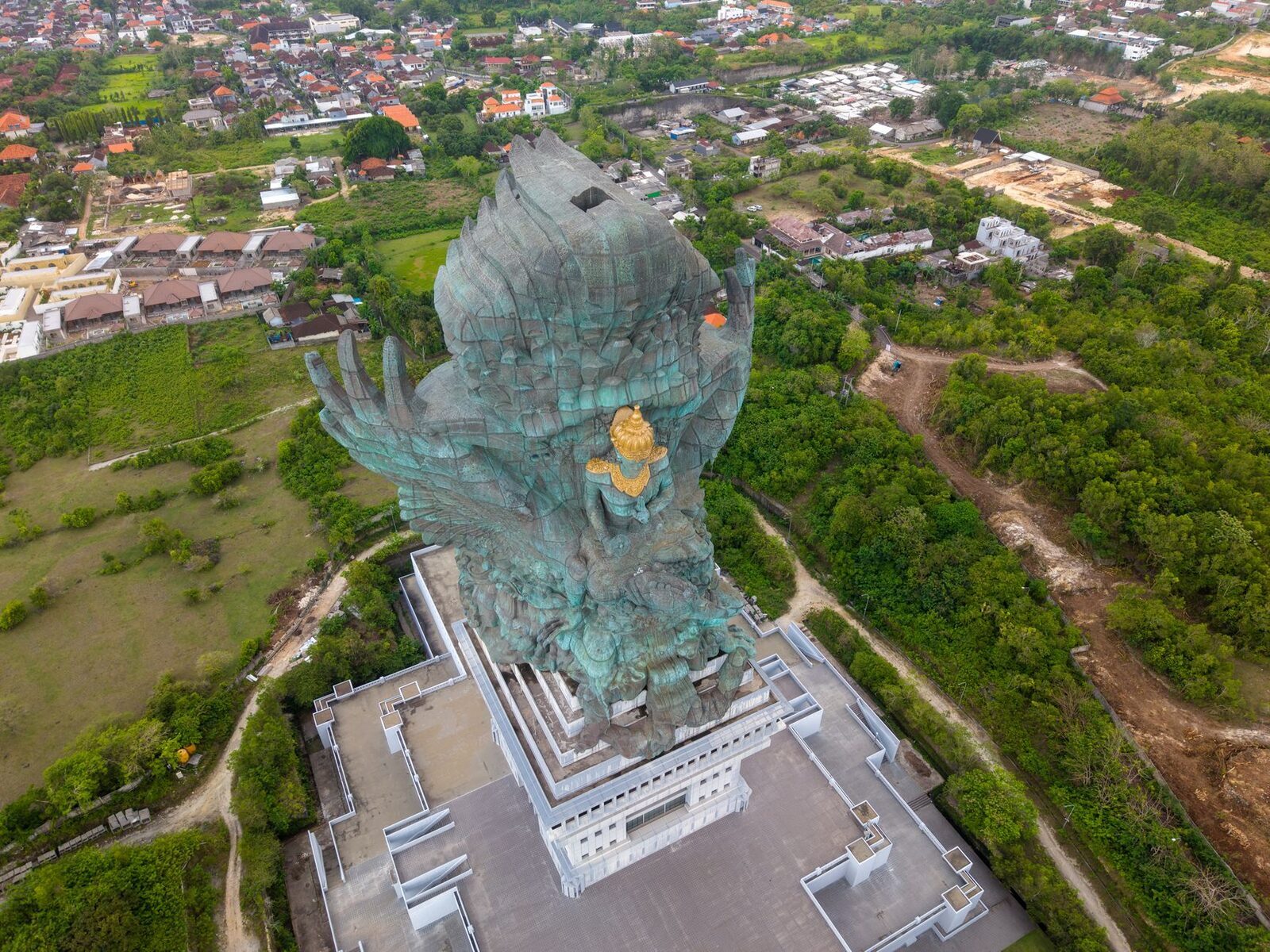 From the air: the god-and-eagle towering over the park and the surrounding Bukit hills, which gives the true sense of scale.