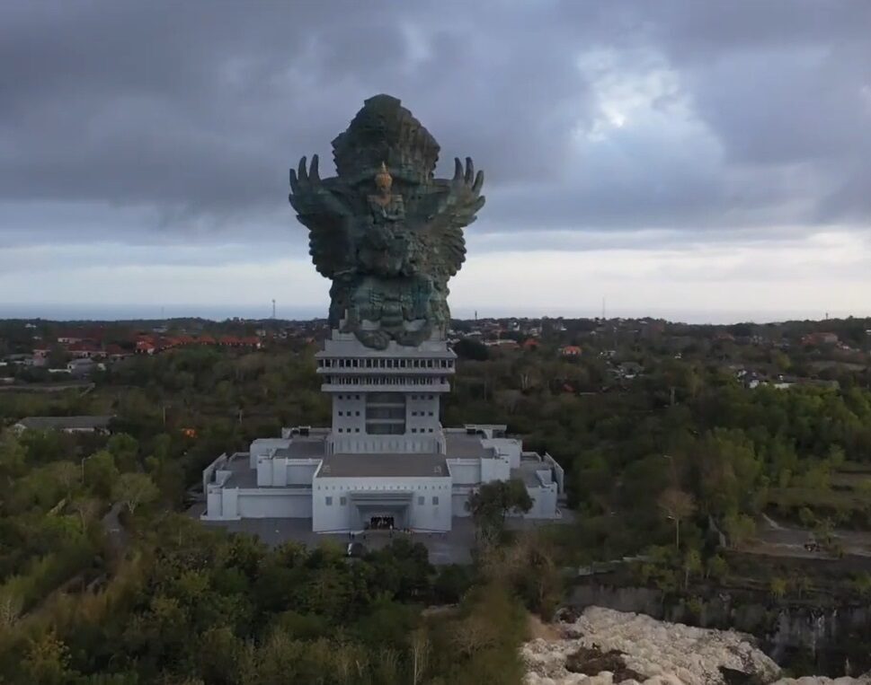 The statue on its plateau under a heavy sky, visible for miles across the Bukit.