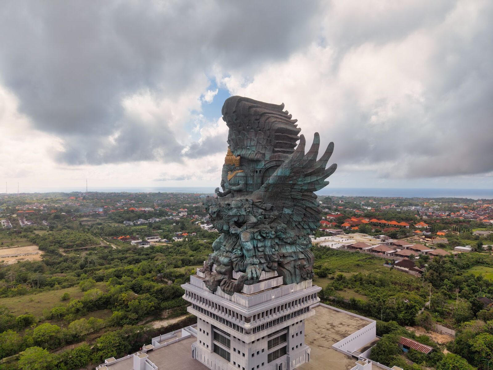 An aerial view of the monument over the wooded plateau on a cloudy day.