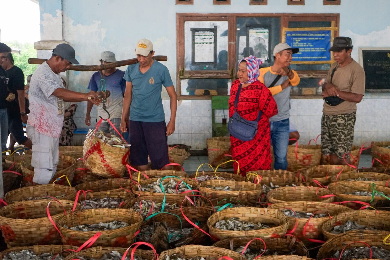 Baskets of the morning catch as buyers and sellers haggle over them.