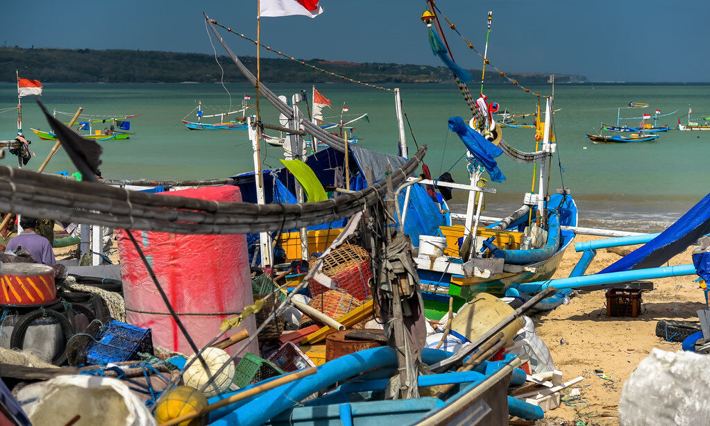 The brightly painted outrigger fishing boats pulled up on the sand.