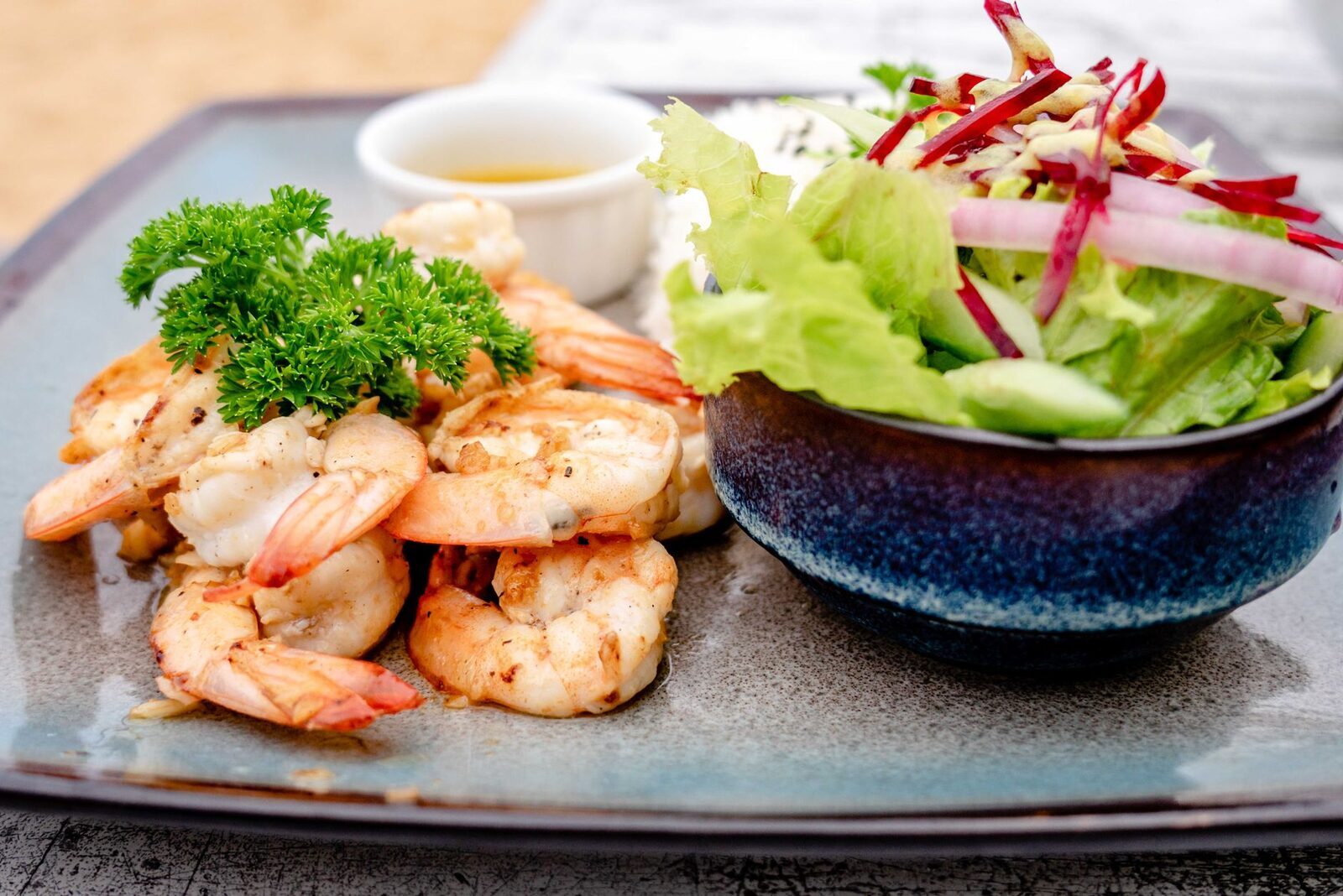 Grilled prawns served with a simple salad.