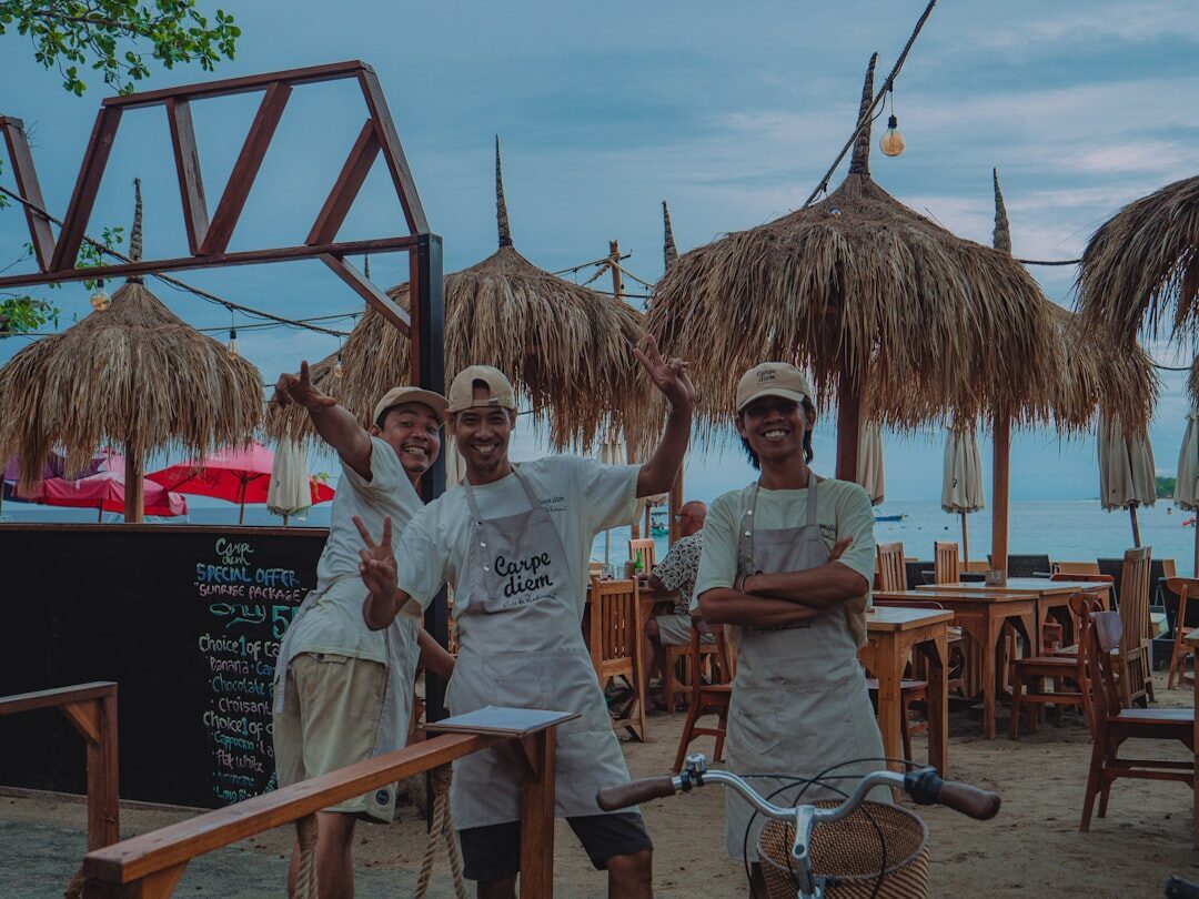 Warung staff at their beachfront pitch under the thatched umbrellas.