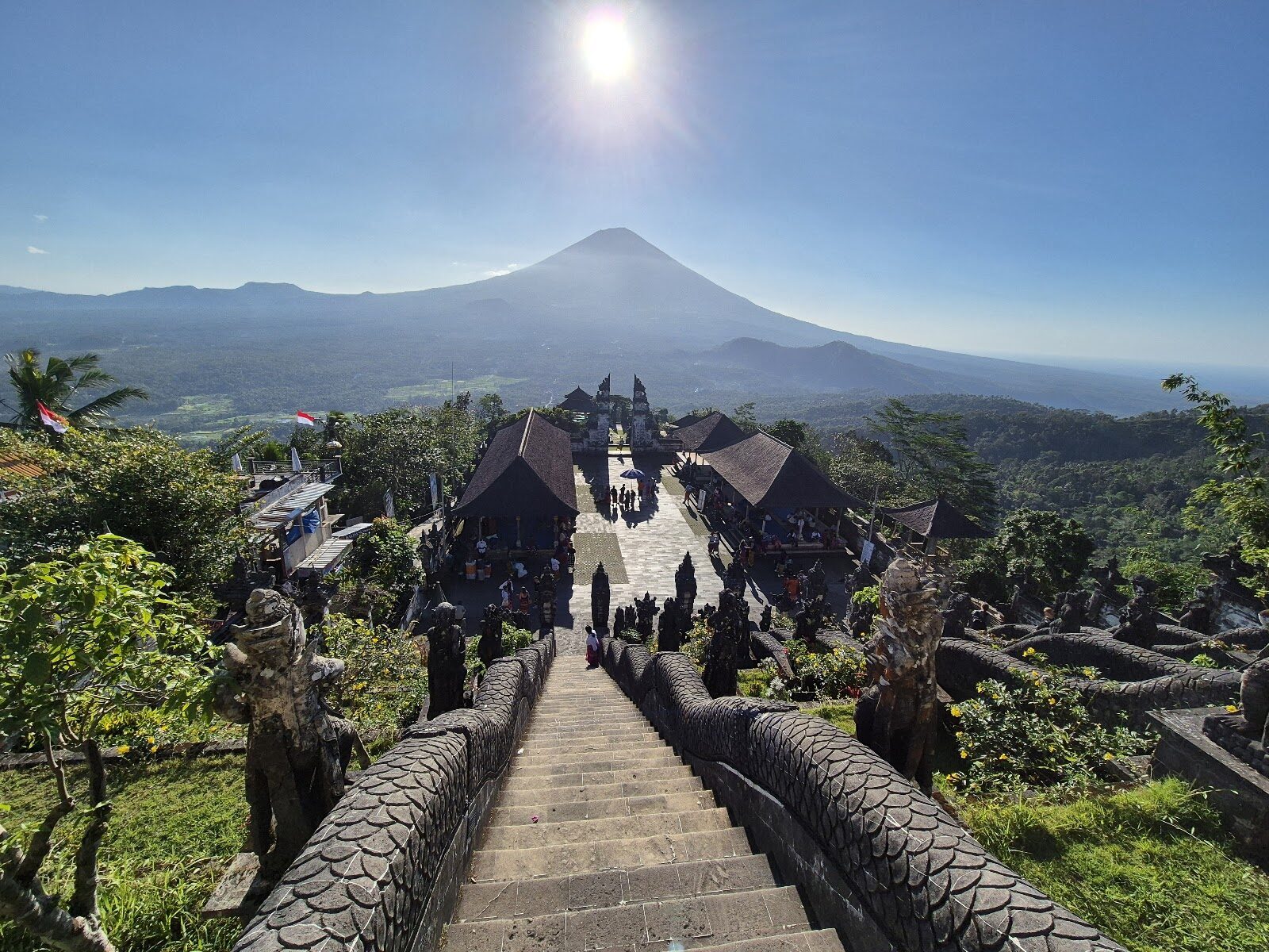 The paved approach to an upper temple, the volcano hazed behind at first light.