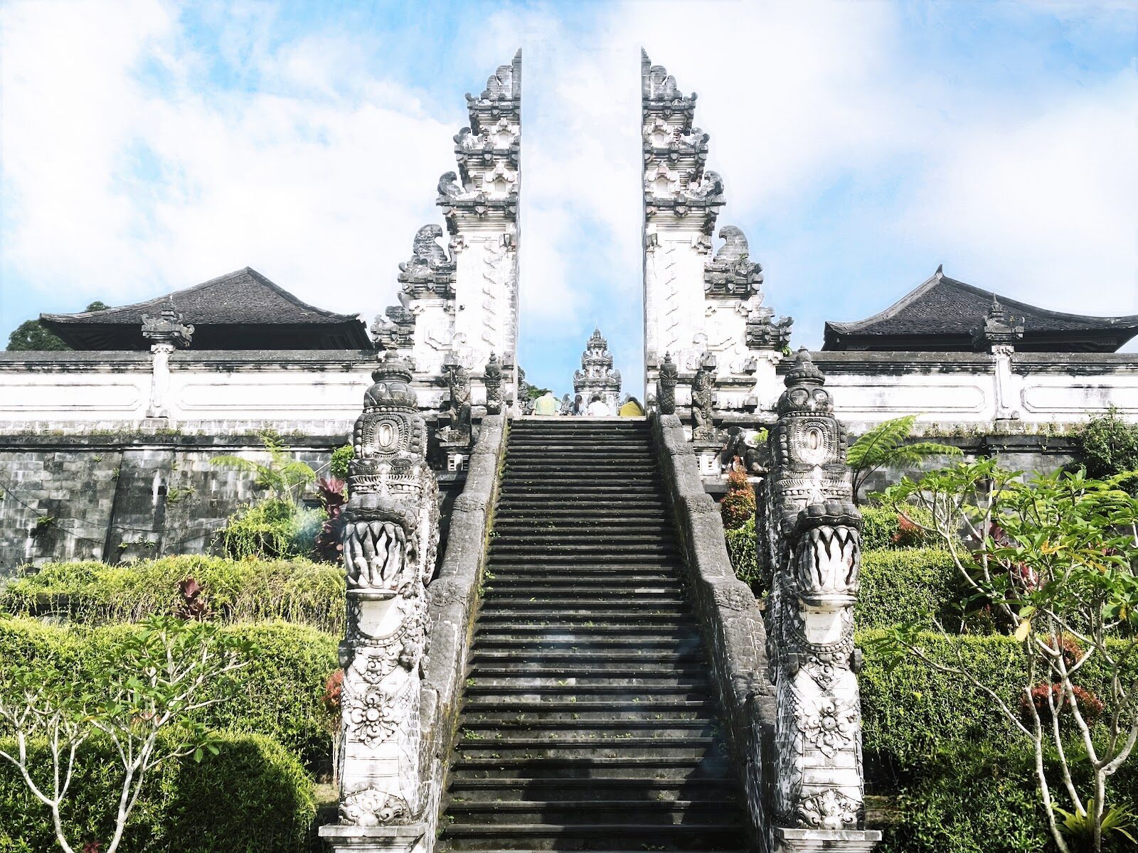 Dragon-flanked steps rise through the split gate toward the temple courtyards.