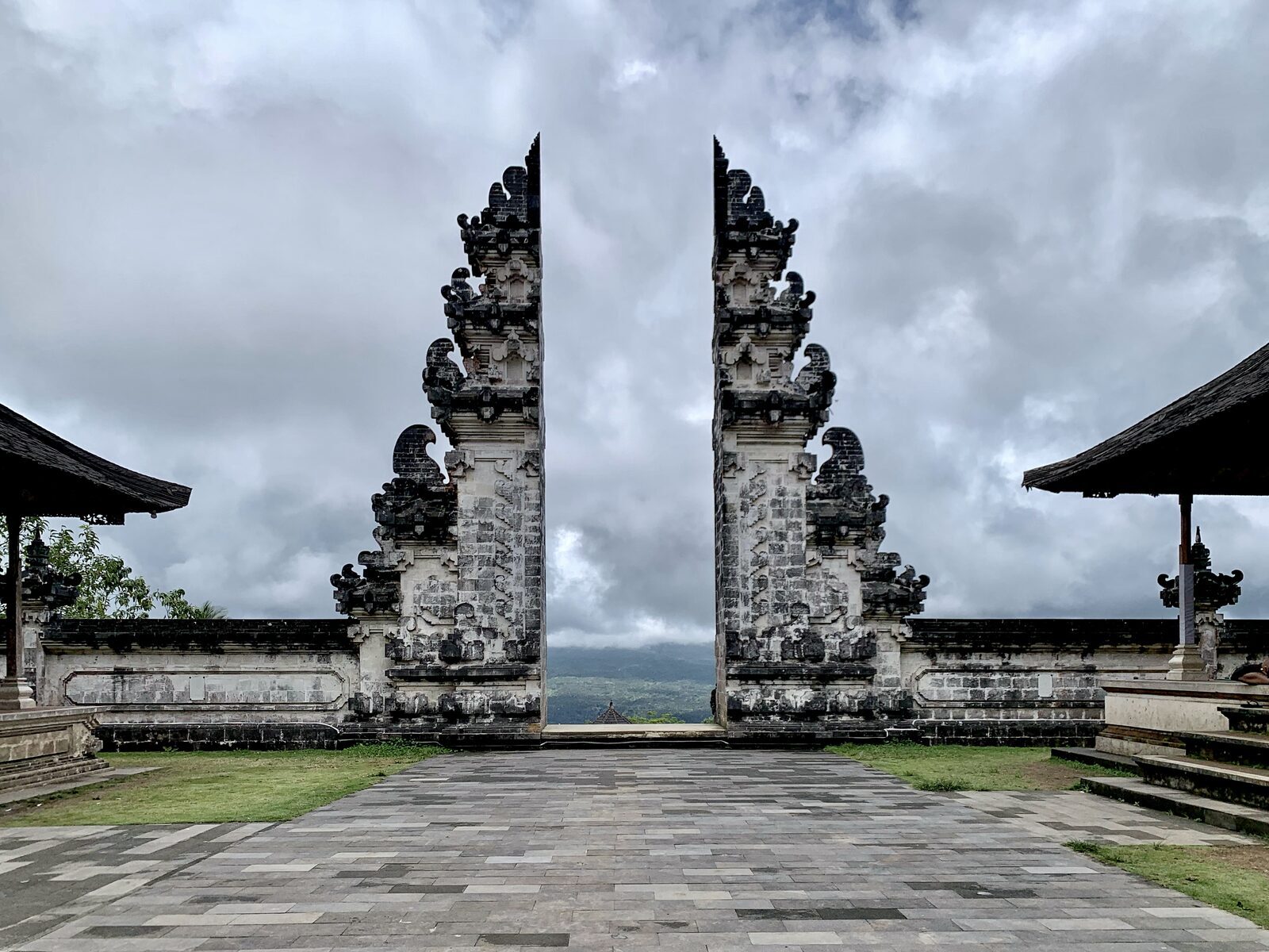 The empty gate under a clouded sky, before the day's queue forms.