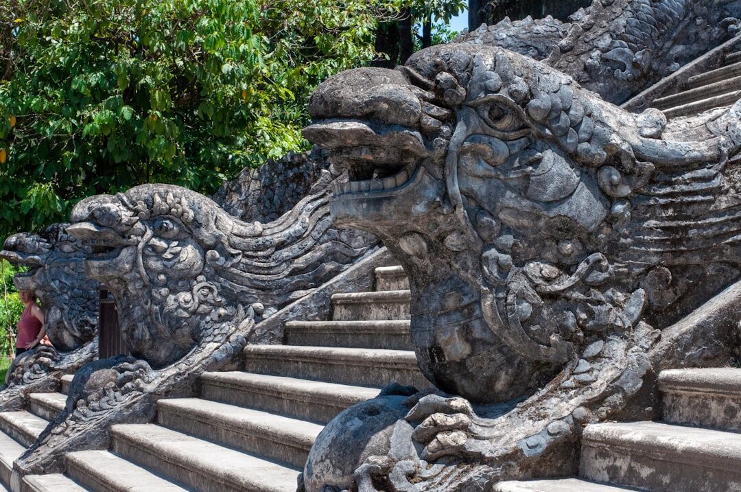 A carved naga (dragon) coils down the balustrade, guarding the climb.