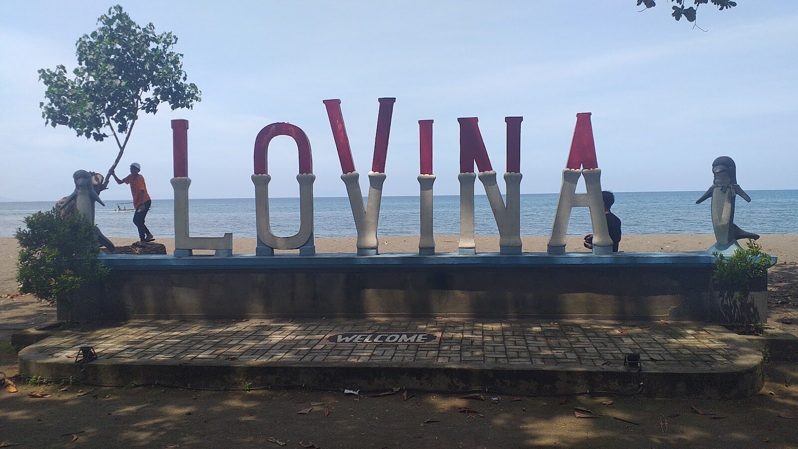 The Lovina beachfront sign — the low-key marker of a town that's still more fishing village than resort.