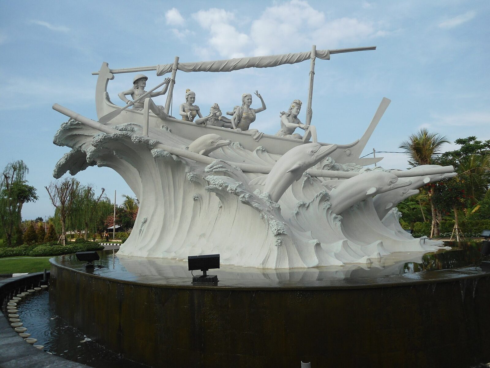A second Lovina seafront sculpture — a boatful of figures riding the wave.