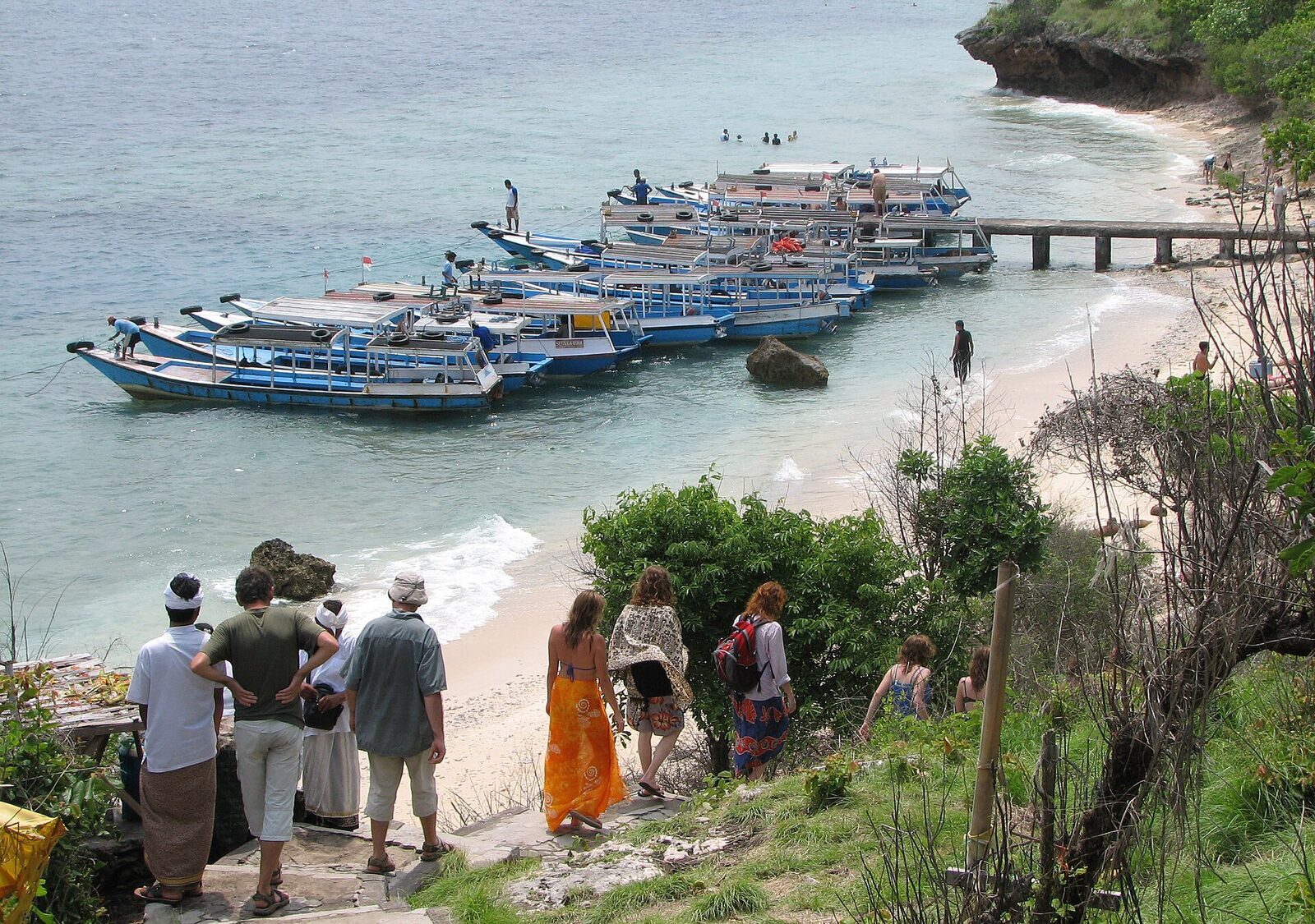 Wooden boats drawn up on the landing beach at the island end.