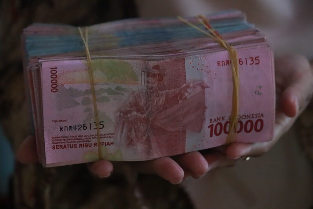 A banded brick of 100,000s — more cash than anyone needs on them at once.