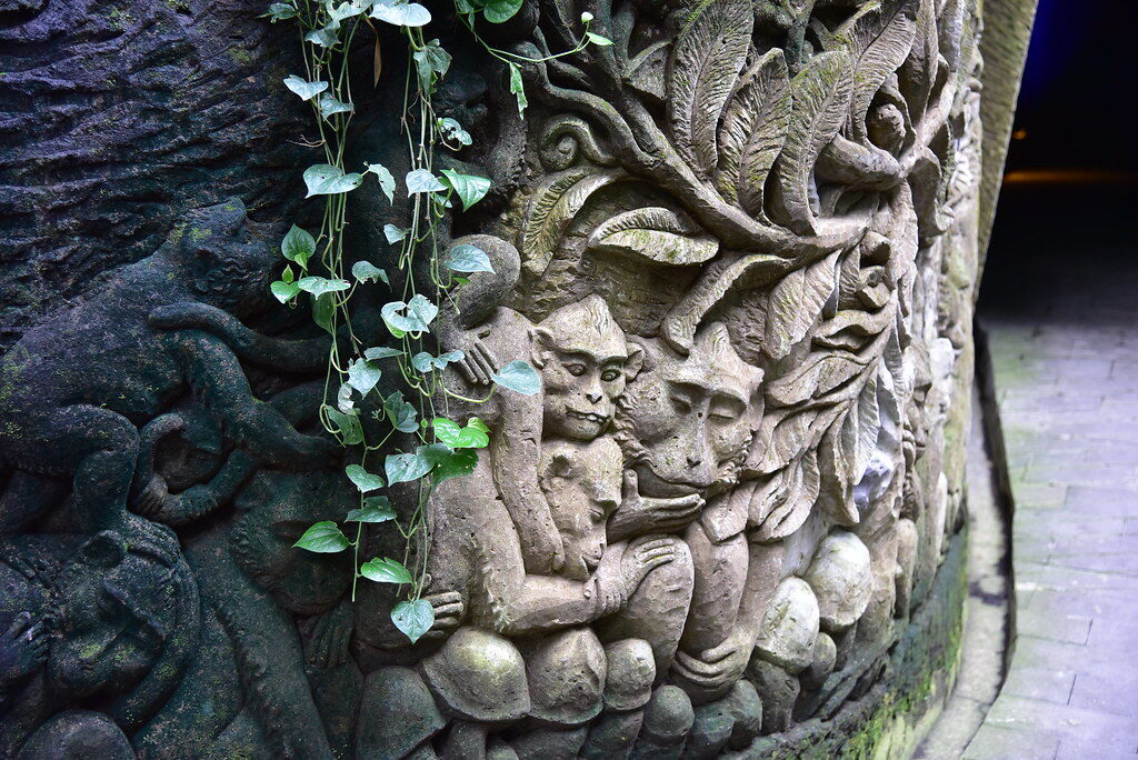 A moss-covered relief on the temple stone, greenery creeping across the carving.