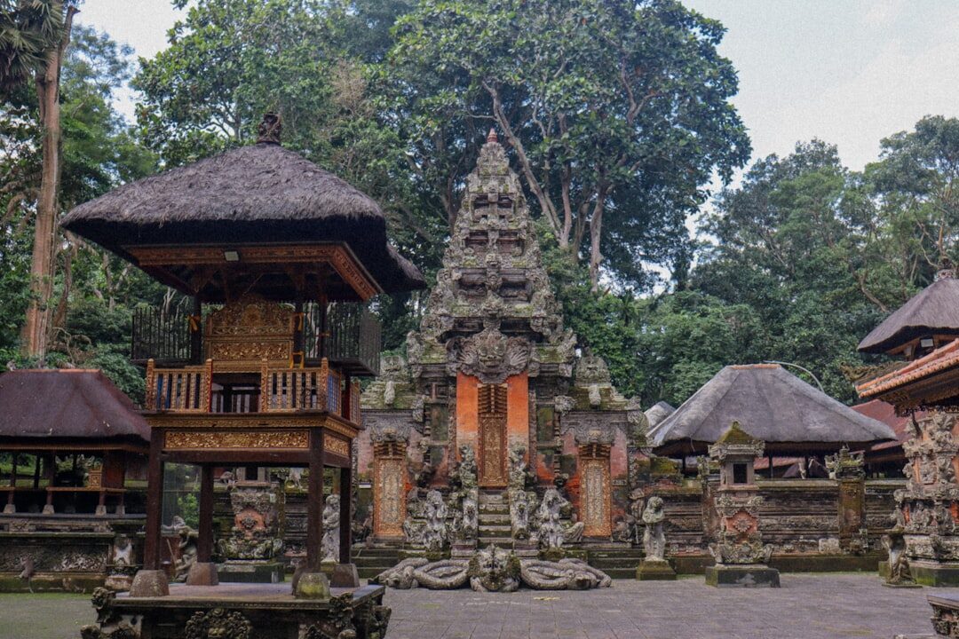 One of the ornate temple gates, its tiered stonework rising into the canopy.