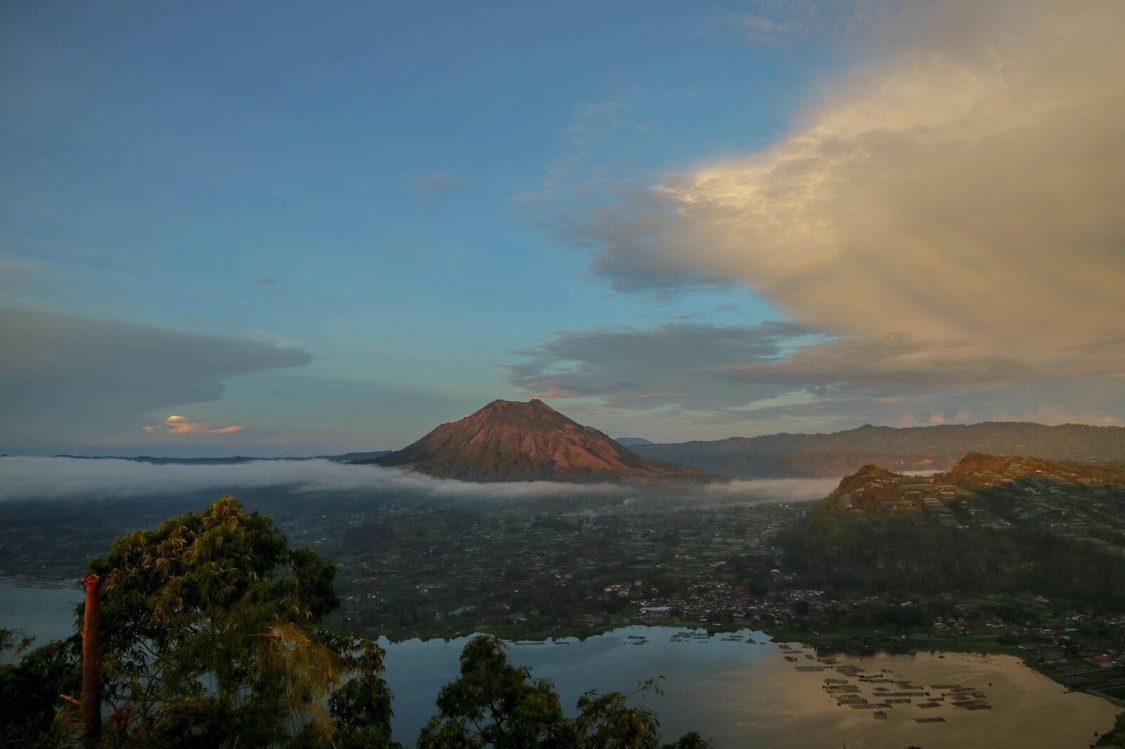 Batur and its caldera lake from the Kintamani rim — the classic, far more casual Bali sunrise view.
