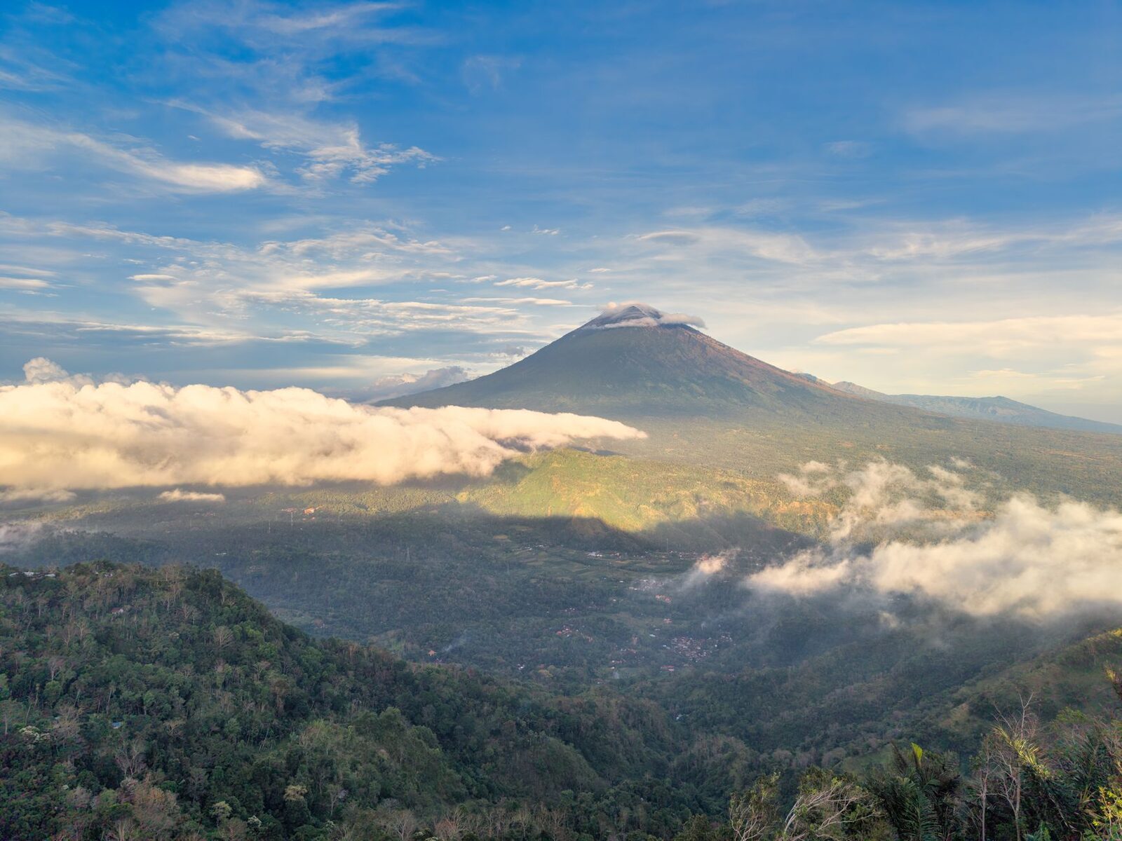 From the air, the summit breaking through the clouds.