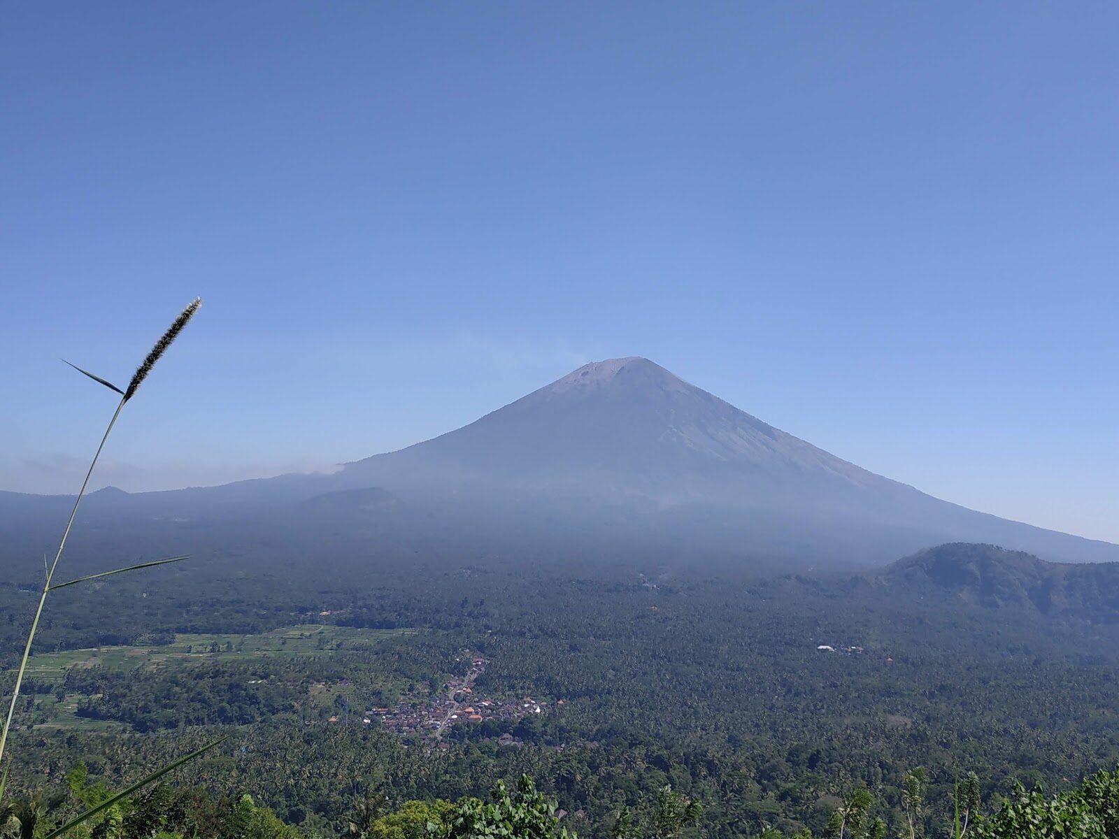 Agung faint through morning haze across the eastern country.