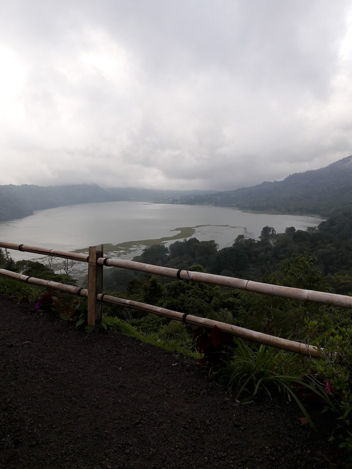 The lake through the haze from a roadside rail — a couple of makeshift photo spots along here ask a few thousand rupiah.