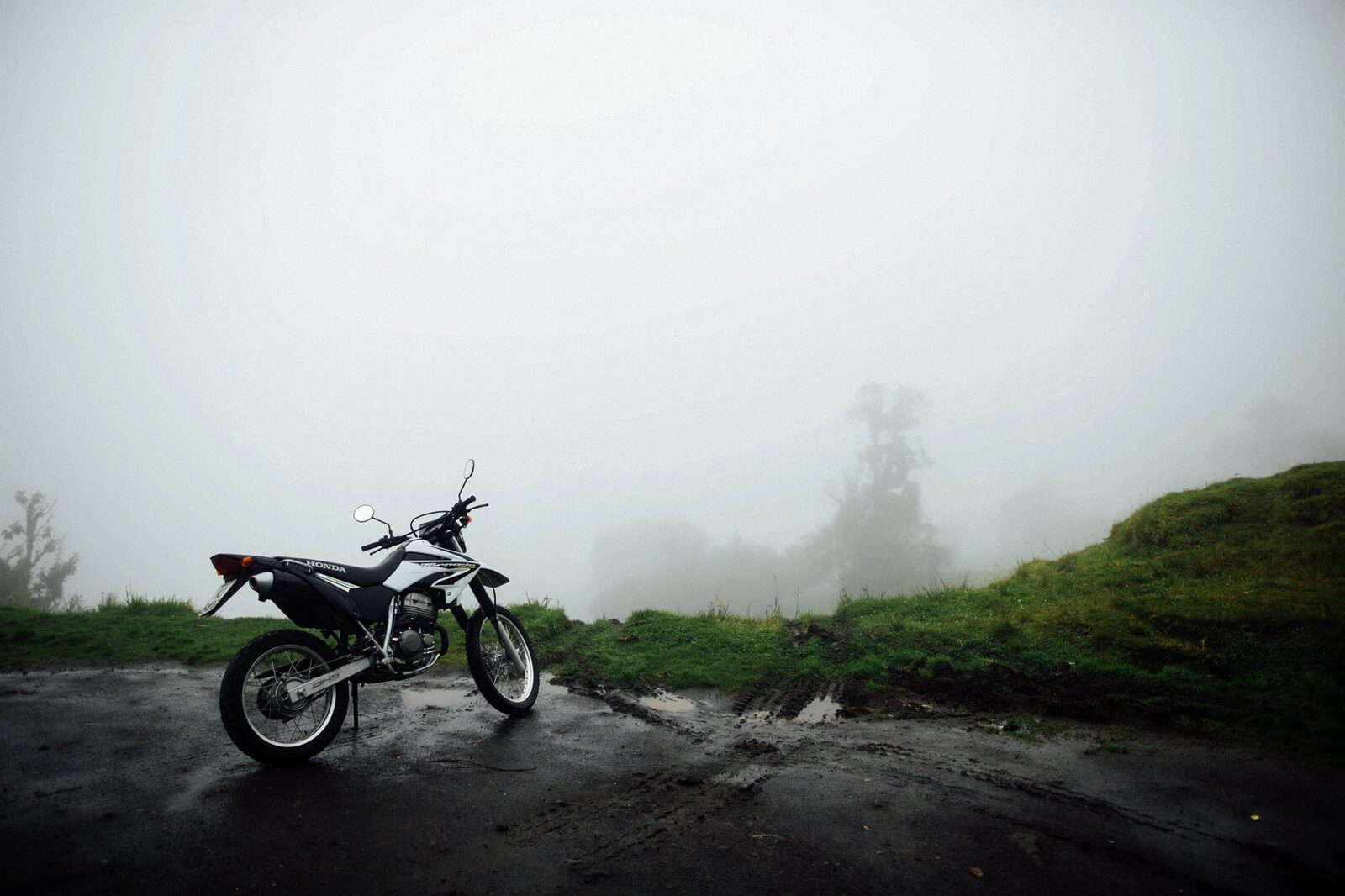 A bike on a fog-bound mountain pass — the roads up here are narrow, wet and steep.