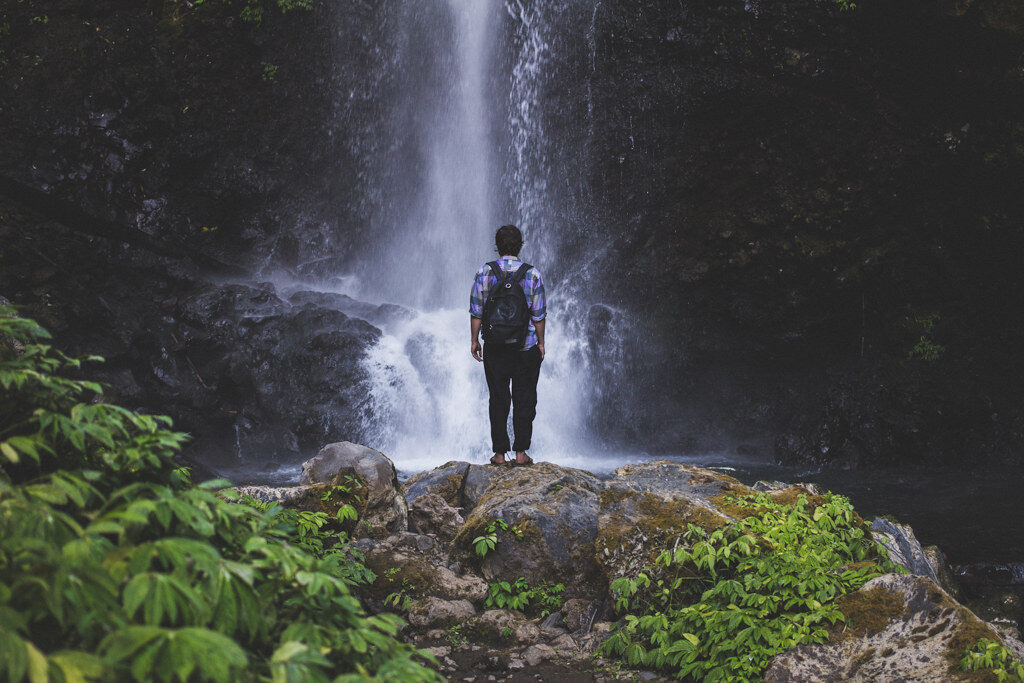 A walker dwarfed at the base — the scale you climb down (and back up) for.