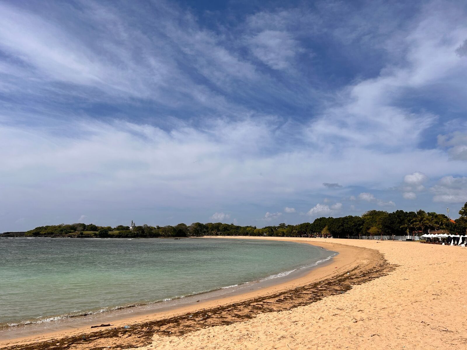 The calm, reef-sheltered curve of Nusa Dua — flat clear water and clean sand, the gentlest swimming in South Bali.