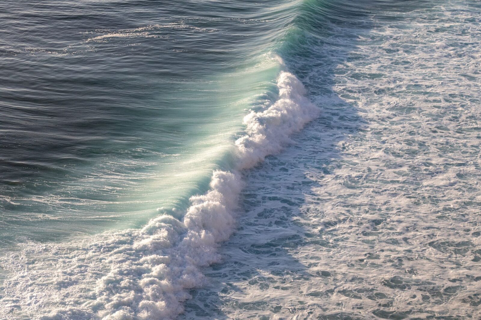The kind of ocean swell that feeds it — stay behind the railings, people have been swept off these wet rocks.