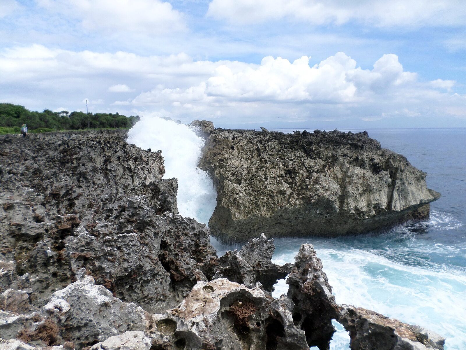 The Water Blow doing its thing — an Indian Ocean swell funnelled into the cleft and thrown up in spray. Worth 15 minutes on a big-swell day.