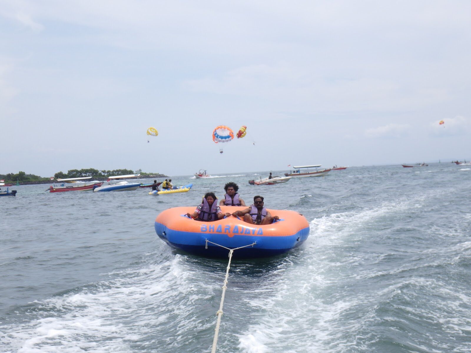 A towable ride bouncing behind a speedboat — the banana-boat end of the menu.