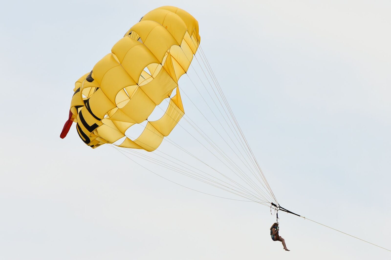 A parasail chute floating back down toward the beach.