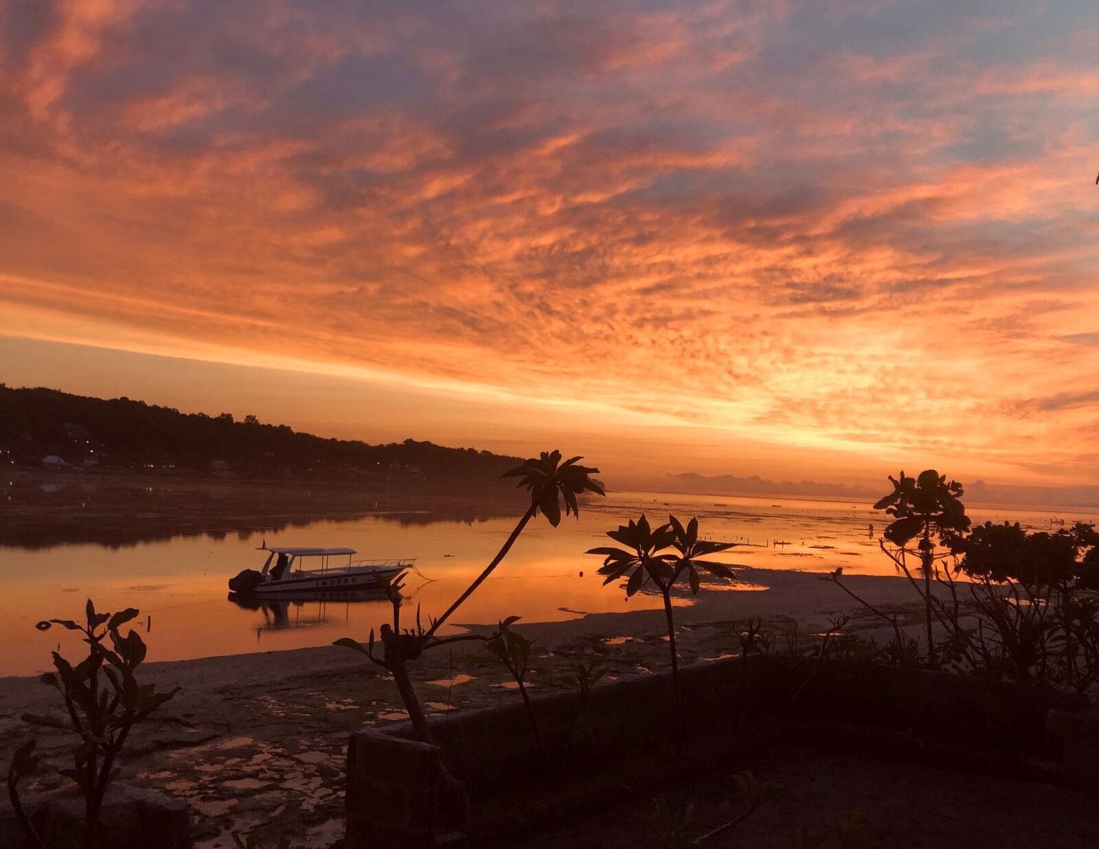 Dusk over the water — the crossing is calmest early and late in the dry season.