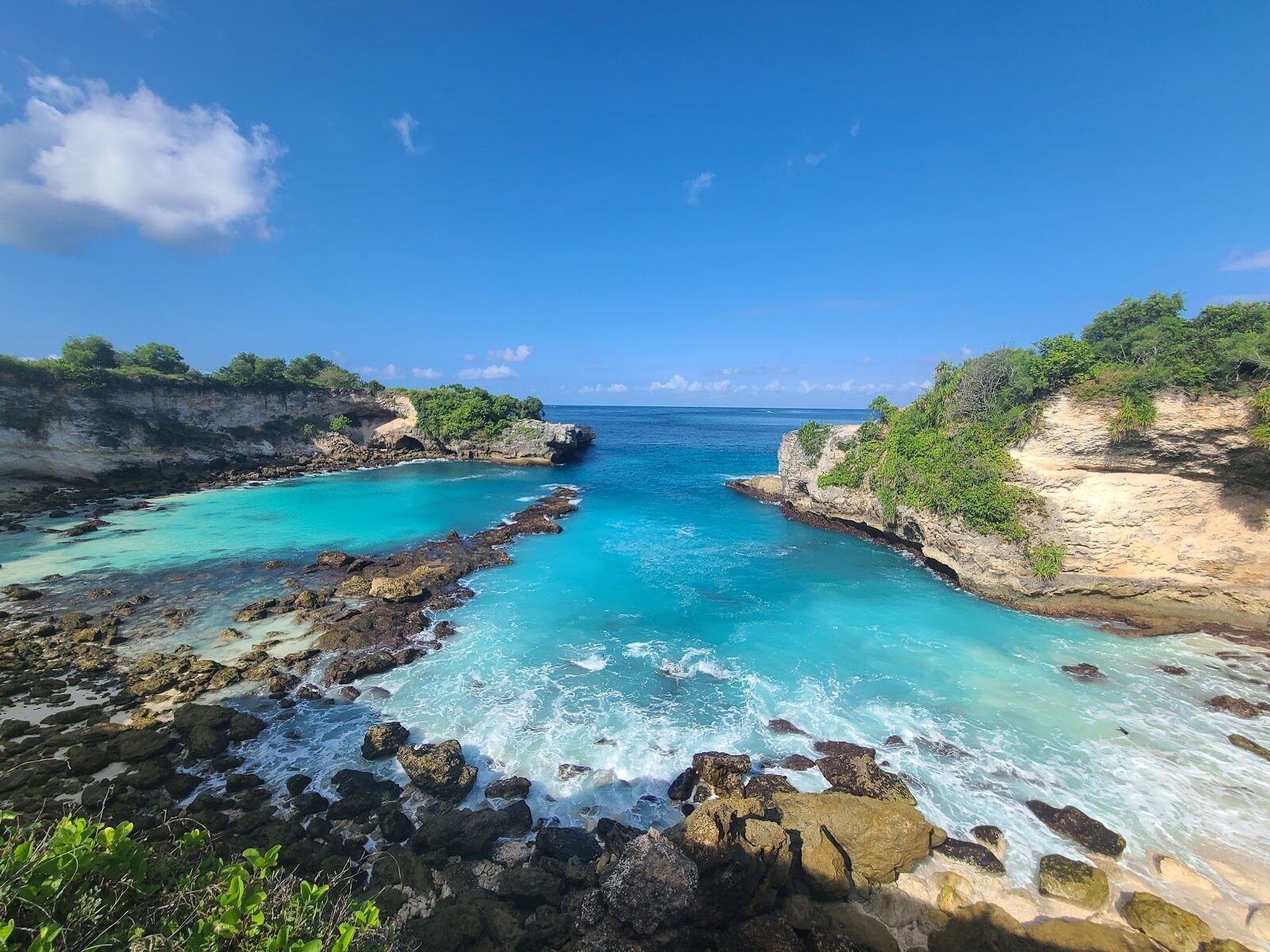 The Blue Lagoon on Ceningan — a slot of vivid turquoise water walled by low cliffs, and a well-known cliff-jump spot.