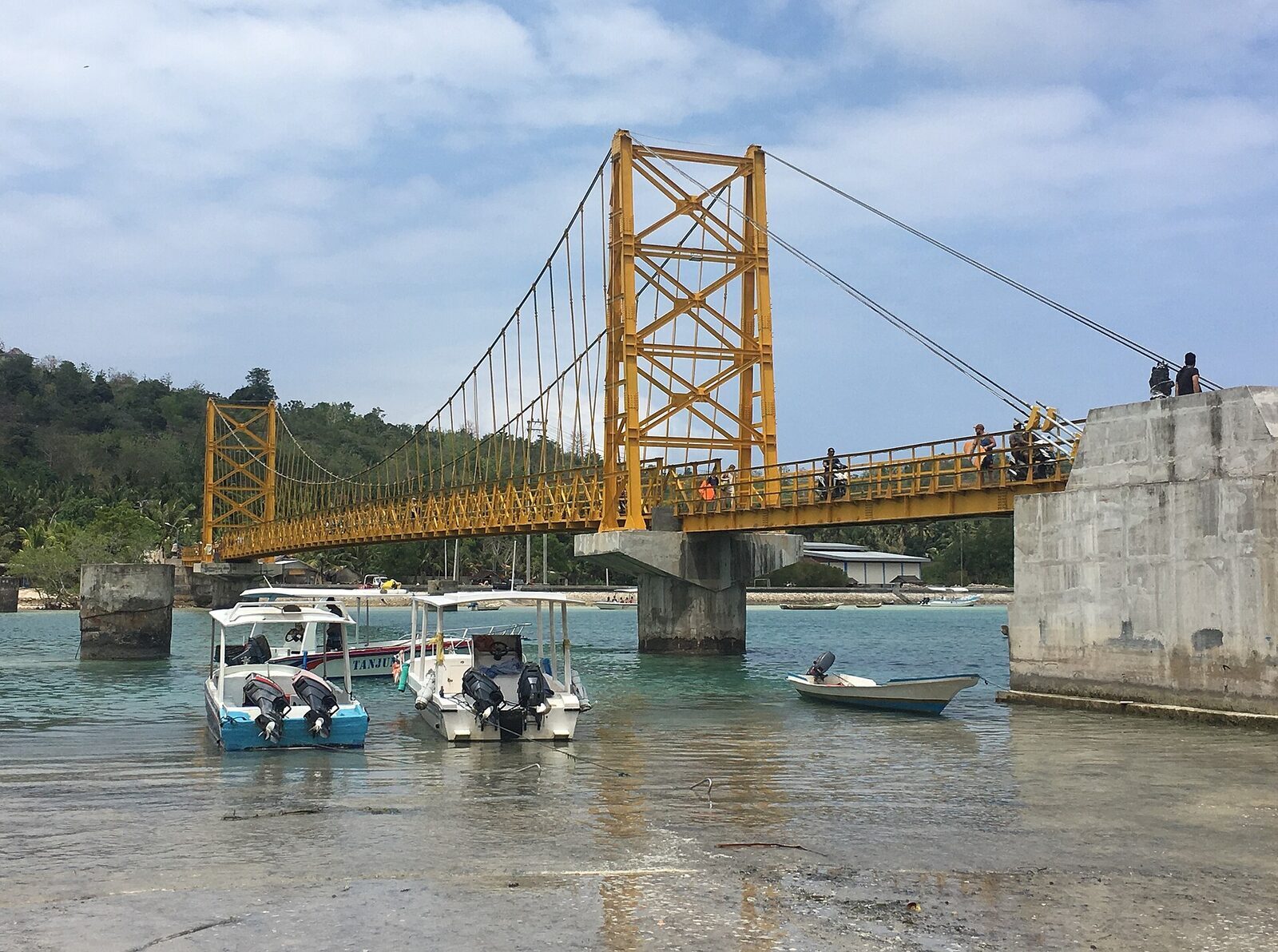 The yellow suspension bridge linking Lembongan and Ceningan — the tiny island's landmark, wide enough for scooters only.