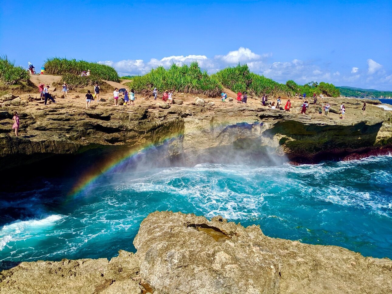 Devil's Tear on Lembongan — swells exploding against the rocks, throwing spray and rainbows.