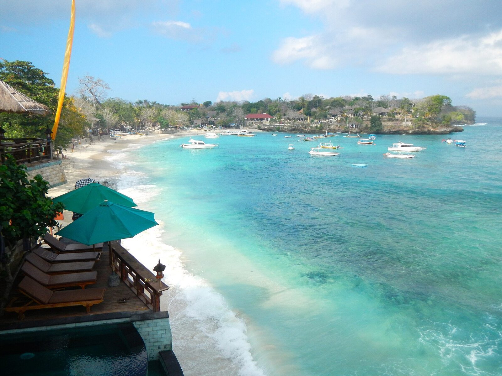 Mushroom Bay from above — the calm, cafe-lined water that makes Lembongan the easy island.