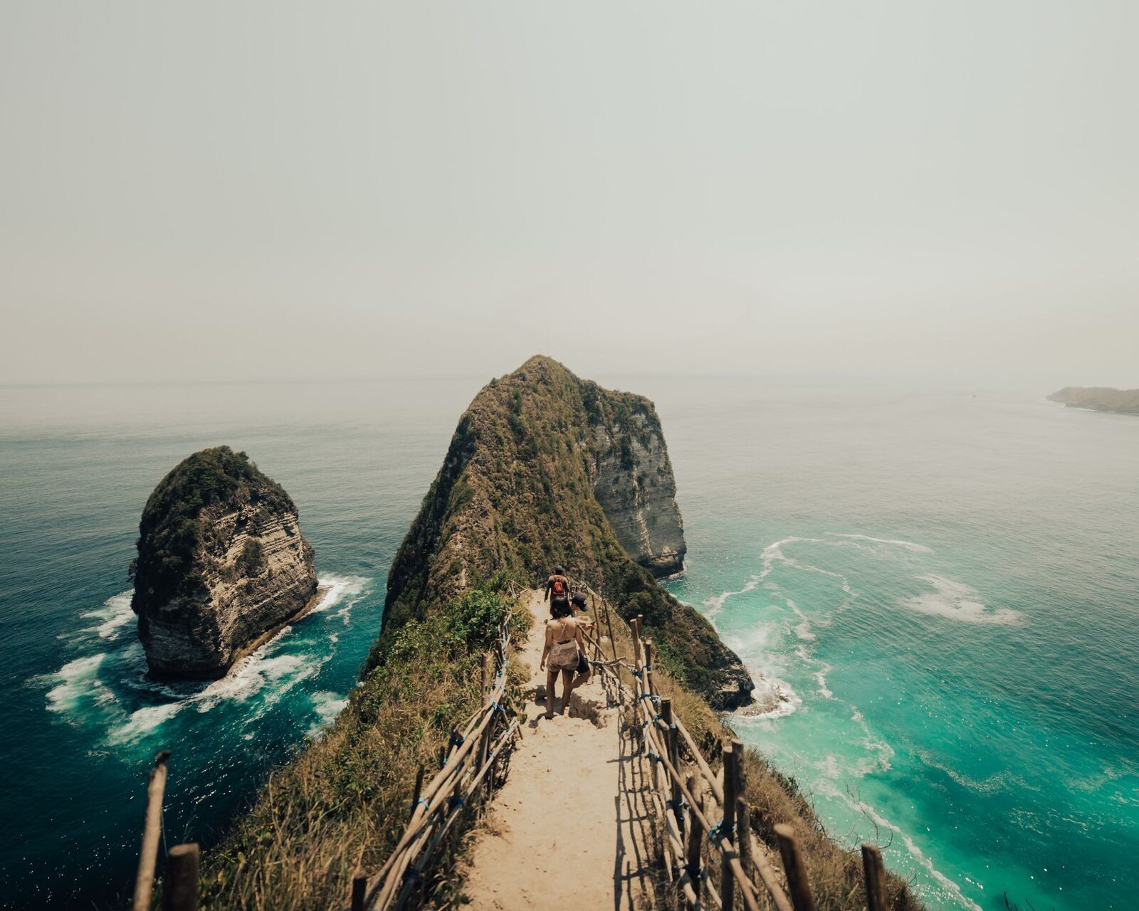 A narrow, exposed clifftop path on Penida — the terrain is steep and unforgiving off the main tracks.