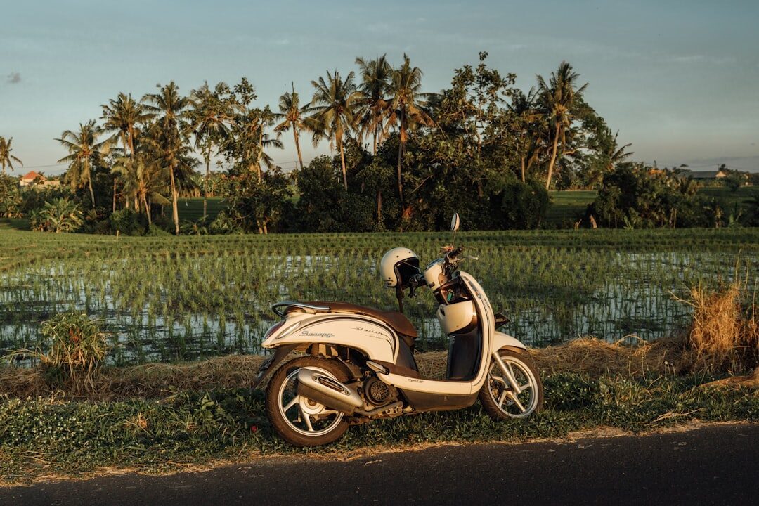 A parked scooter — the default rental, fine on flat Lembongan, a real risk on Penida's hills.