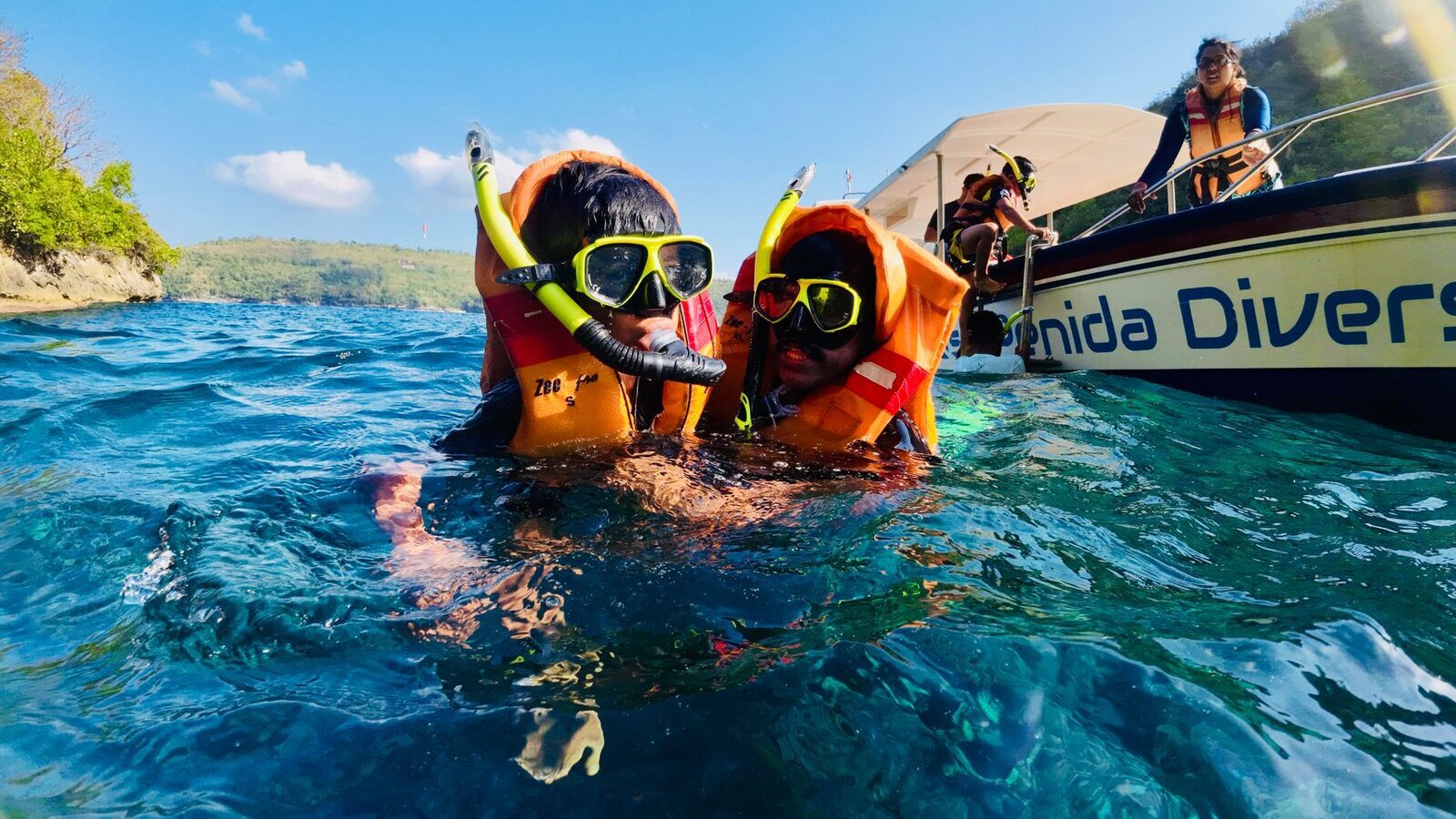 Snorkellers in life jackets over the reef off Nusa Penida — the easy, guided version.